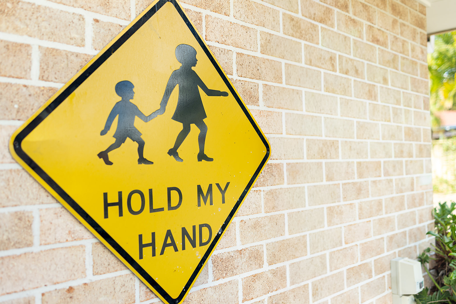 Oz education boambee east centre outdoor area hold my hand sign