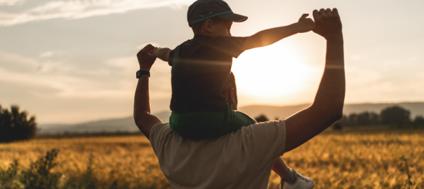father and son looking at sunset