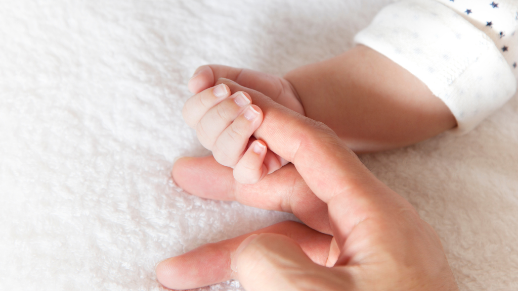 newborn holding mother's hand newborn holding mother's hand