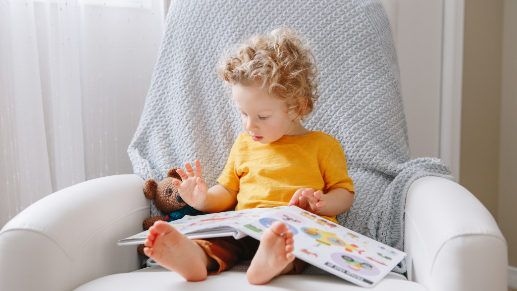child reading in armchair