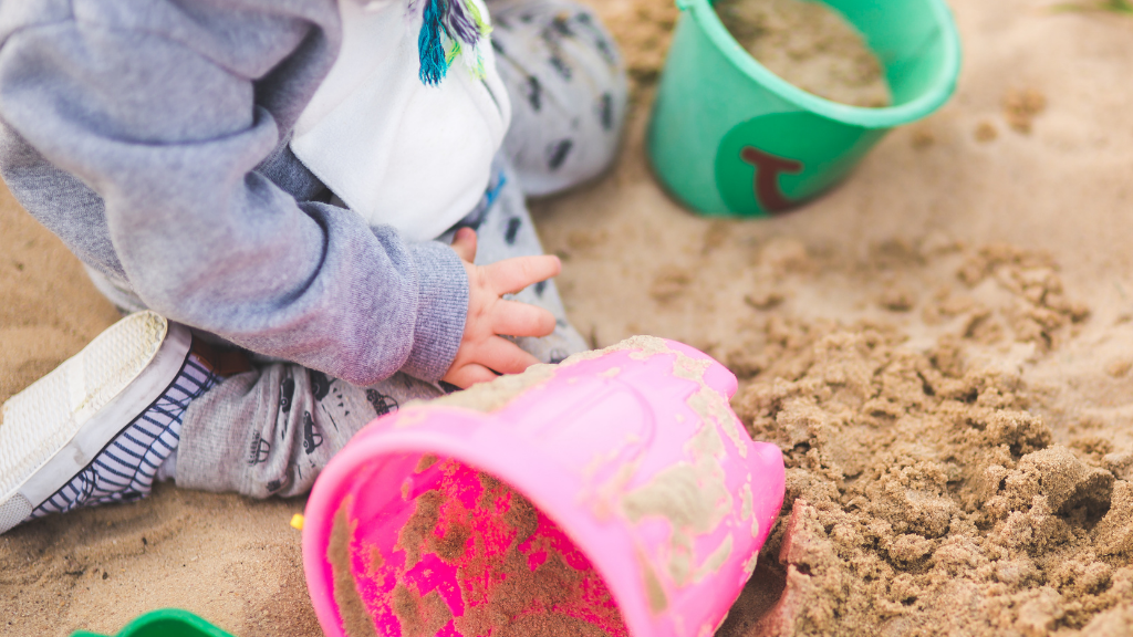 outdoor play1 child playing in sandpit