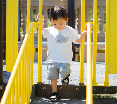 child carefully playing in playground
