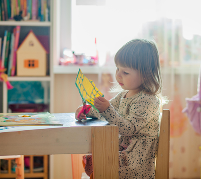 School Readiness 4 child cutting paper learning for school