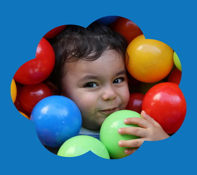 child smiling with colourful balls