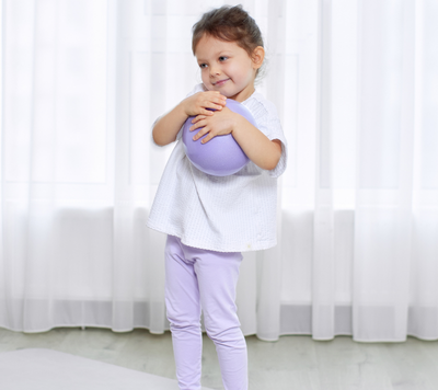 happy girl holding ball for rhythmic