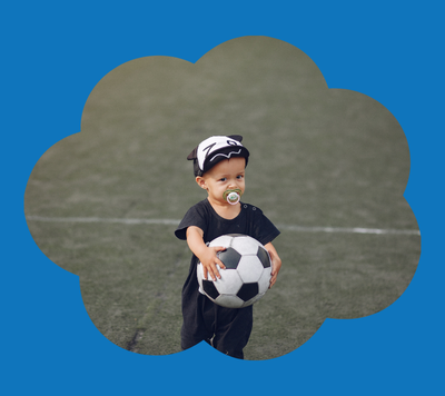 child holding soccer ball to play