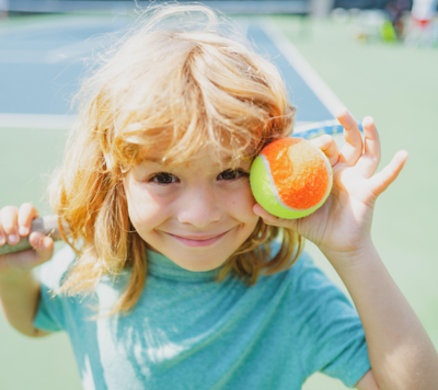 Space Ball child holding tennis ball to play sports