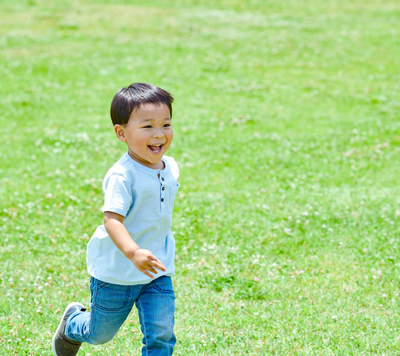 Tee Ball child running and smiling to play tee-ball