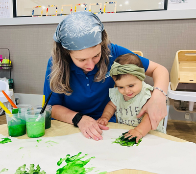 educator and child painting