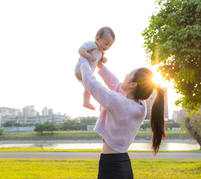 Baby and mum playing outside