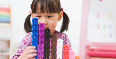 girl counting blocks
