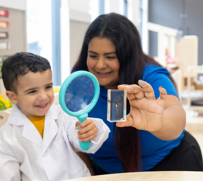 stem learning 3 child STEM learning and holding magnifying glass