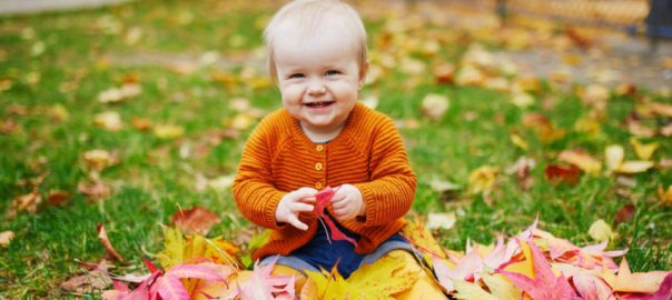 child playing in leaves