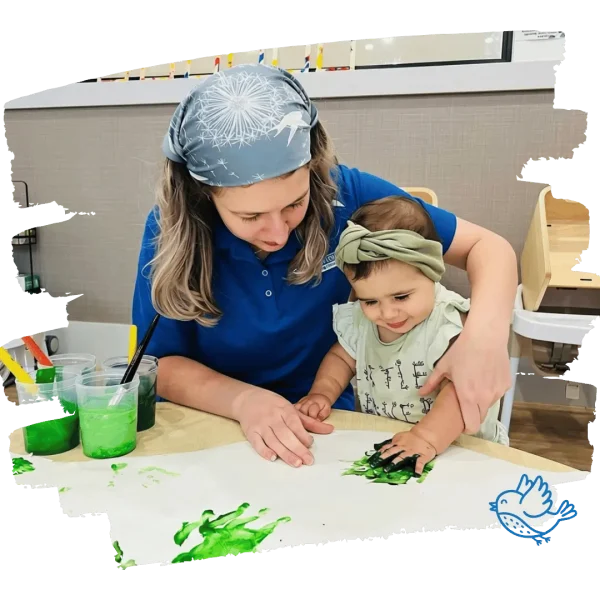 educator and toddler painting