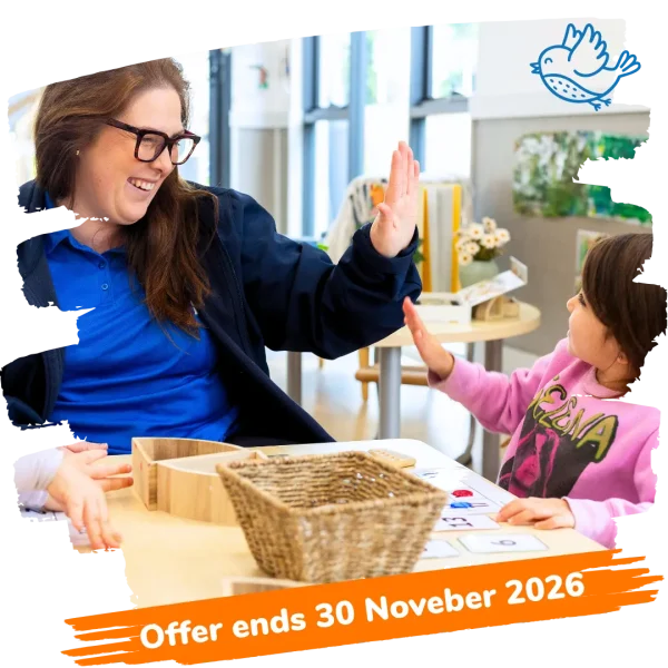 Educator and child high fiving